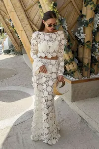 Elegant white French lace two-piece set featuring long sleeve crop top and mermaid skirt