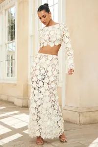 Detail view of a French white 3D floral lace two-piece set with crop top and maxi skirt