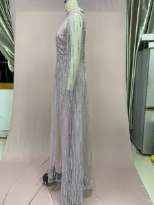 Detailed side view of pink mesh evening dress with silver sequin fringe stripes on a mannequin.