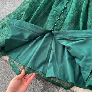 Gros plan d'une robe vert émeraude avec broderie florale et doublure