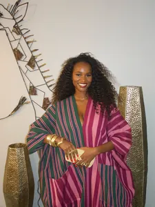 Detail of a plus size African style maxi dress with vibrant multi-colored stripes
