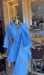 Elegant blue and white striped shirt dress featuring a large front bow detail.