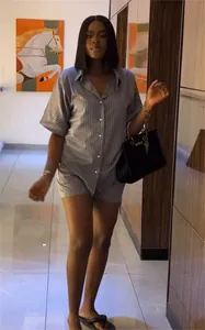 Femme portant une chemise à rayures à manches courtes et un short à taille haute.