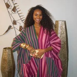 Model wearing a vibrant African-inspired oversized color block striped maxi dress