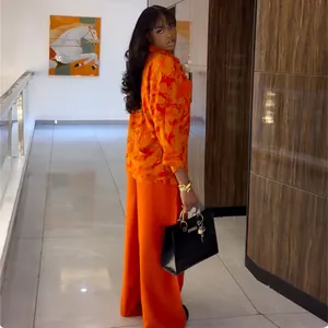 A detailed look at the 2025 autumn floral shirt and orange wide-leg pants set for women