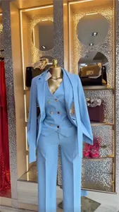 Elegant light blue three-piece suit set with blazer vest and trousers in a boutique