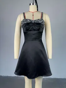 Elegant black sequin patchwork cocktail dress with spaghetti straps on a mannequin