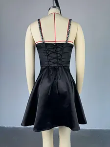 Detailed back view of a black satin cocktail dress with sequined straps and lace-up