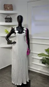 Détail d'une robe longue plissée blanche avec bretelles fleuries en 3D sur mannequin