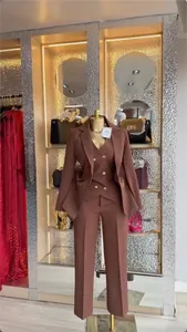 Elegant three-piece brown business suit for women shown on boutique mannequin display
