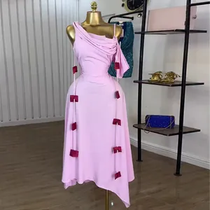 Elegant pink one-shoulder midi dress with spaghetti straps and decorative bow accents