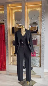 Elegant women's black 3-piece commuter suit with blazer, vest, and trousers set.
