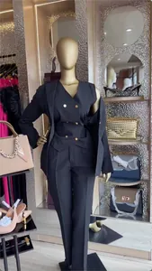 Detailed view of women's black three-piece business suit on display in a boutique
