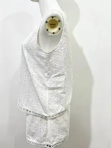 Side view of white broderie anglaise summer two-piece set featuring eyelet embroidery detail