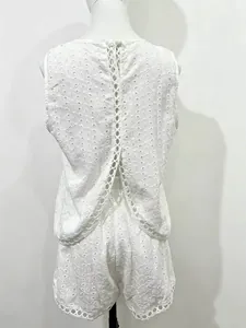 Detailed close-up of white eyelet embroidery backless vest and shorts two-piece set