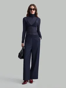 Elegant navy blue sheer mesh turtleneck top with long sleeves and ruffled hem detail