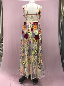 Detailed back view of an elegant beige maxi dress with vibrant 3D floral embroidery