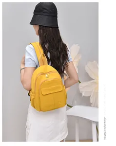 Detailed view of a trendy yellow mini nylon backpack on model for daily travel