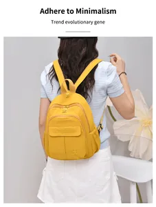 Back view of a yellow lightweight nylon mini backpack for women in minimalist style