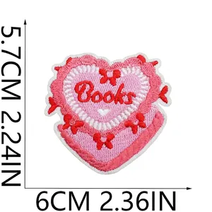 Close-up of heart-shaped 'Books' embroidered patch with size dimensions in cm and inches.
