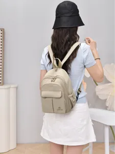 Mini lightweight nylon backpack for women with multiple pockets in beige colorway