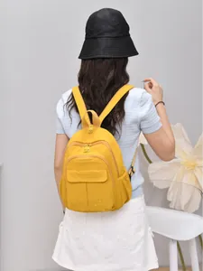Lightweight yellow mini waterproof nylon backpack for women featuring multiple pockets