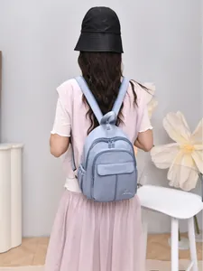 Stylish light blue waterproof nylon mini backpack for women for casual outings.