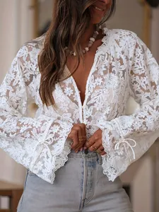 Close-up detail of white floral hollow-out lace long sleeve casual blouse with V-neck