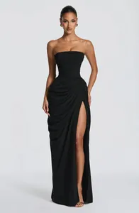 Elegant black strapless maxi dress featuring asymmetrical ruching and a high leg slit detail.