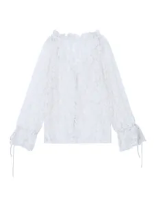 Detailed macro view of white floral lace fabric on a feminine ruffle neck blouse