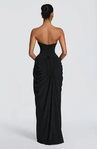 Detailed back view of an elegant black strapless corset dress with draped pleats.