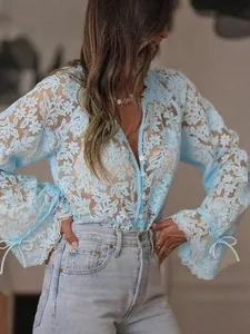 Detailed view of light blue floral lace shirt featuring delicate hollow-out patterns.