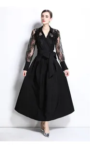 Elegant black dress featuring intricate lace embroidery sleeves and textured long skirt.