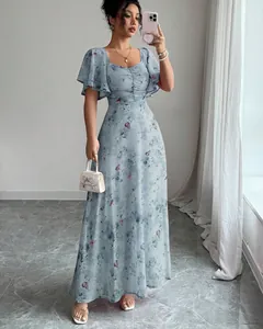Detailed view of elegant blue floral butterfly print maxi dress with flutter sleeves.