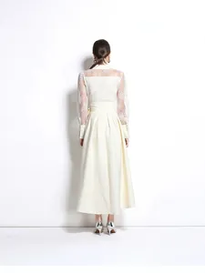 Back view of an elegant cream long dress with lace embroidery and textured fabric