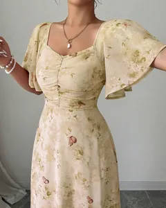 Close-up detail of a floral print dress with ruffle sleeves and ruched sweetheart neckline