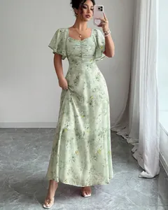 Full view detail of a light green floral maxi dress with elegant flutter sleeves and ruched bodice