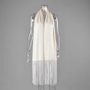 Close-up detail of a cream satin waist seal accessory featuring long white fringe trim