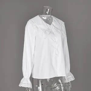 Detailed view of white cotton French style blouse with lace-edged double Peter Pan collar