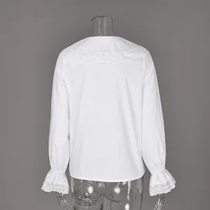 Back view of a white French cotton blouse featuring a lace-trimmed collar and ruffle sleeves.