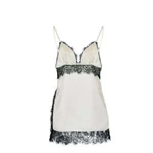 Close-up of elegant ivory satin camisole featuring intricate black lace trim details