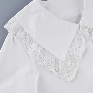 Close-up detail showing the elegant lace embroidery on a white French cotton blouse collar