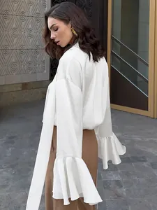 Side view of elegant white satin blouse featuring flowing tie-neck and ruffled cuffs.