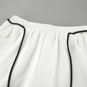 Gros plan sur la taille élastique et le cordon de serrage noir d'un jogging blanc