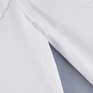 Close-up macro detail of a white pure cotton French shirt showing fine lace and seam