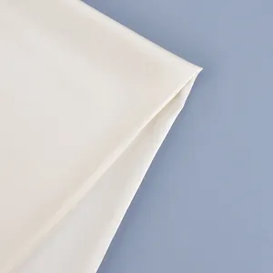 Detail view of premium cream satin fabric showing the smooth texture of this tie-up waist belt