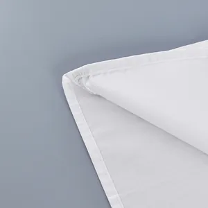 Detailed close-up of a white cotton French shirt showing fine stitching and fabric texture