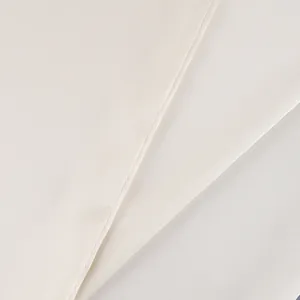 Close-up detail of premium off-white satin fabric texture and stitching for waist belt