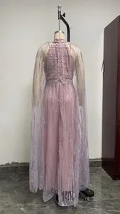 Elegant mauve sequined evening gown with sheer mesh cape detail on mannequin stand