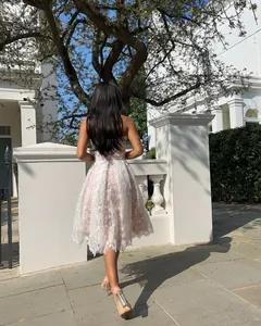 Back view of elegant white lace strapless dress with floral embroidery and A-line skirt